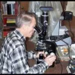 Dr. Gentry looking through an electron microscope at pollium halos in granite.